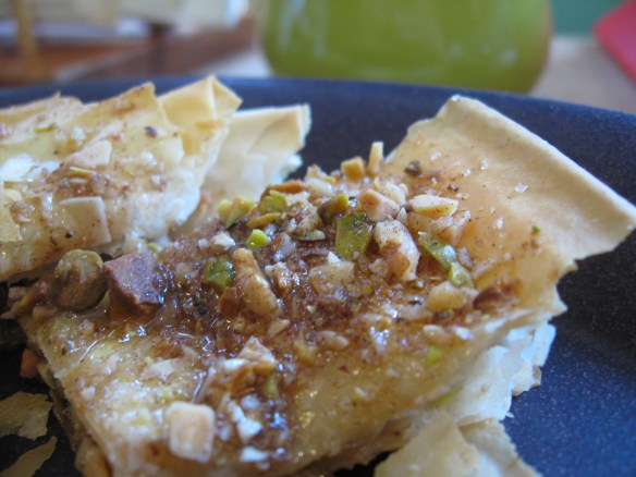 Plated baklava, glistening with honey and crystals of sugar