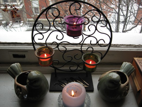Candles in the yoga room; snowy street outside.